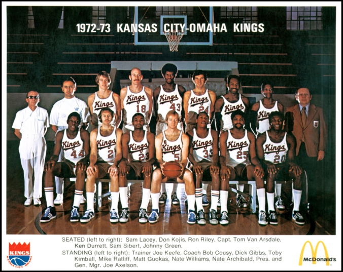 1972-73 Kansas City-Omaha Kings basketball team. Seated (l-r): Sam Lacey, Don Kojis, Ron Riley, Capt. Tom Van Arsdale, Ken Kurrett, Sam Sibert, Johnny Gree. Standing (l-r): Trainer Joe Keefe, coach bob Cousy, Dick Gibbs, Toby Kimball, Mike Ratliff, Matt G